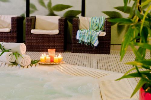 a table with two chairs and candles in the water at Leonardo Club Hotel Dead Sea - All Inclusive in Ein Bokek