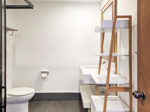 a bathroom with a toilet and a sink at Ponderosa Golf and Resort in Puerto Galera
