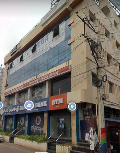 a building on a street in front at CORAL STAYS INN in Vijayawāda