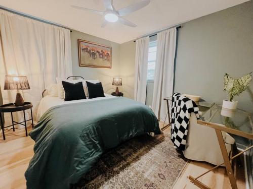 a bedroom with a green bed and a window at Cozy Urban Escape - East Nashville - Dreami Stays in Nashville
