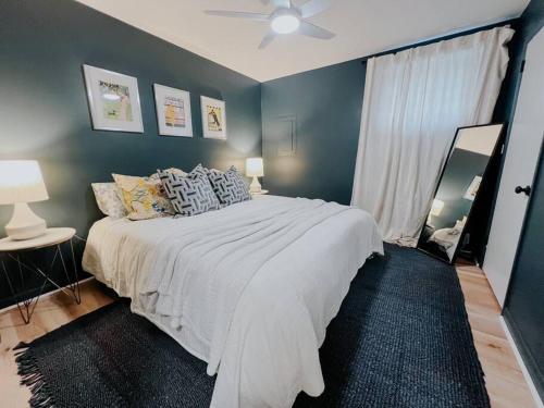 a bedroom with a large bed with blue walls at Cozy Urban Escape - East Nashville - Dreami Stays in Nashville