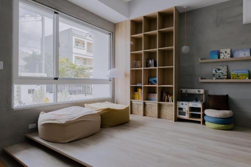 a room with a bed and a large window at Terumahouse 照間 民宿編號2016號 in Taitung City