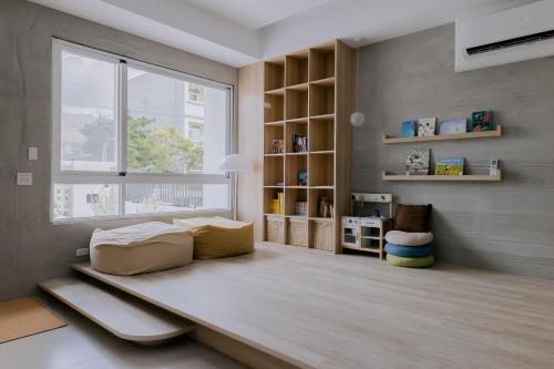 a living room with a couch and a window at Terumahouse 照間 民宿編號2016號 in Taitung City