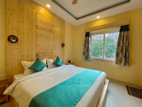 a bedroom with a large bed and a window at Hotel Kedar inn in Rishīkesh