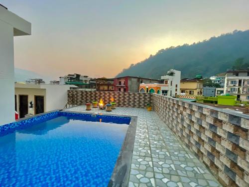 a swimming pool on the roof of a building at Hotel Kedar inn in Rishīkesh