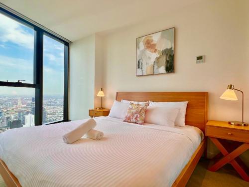 a bedroom with a bed with a teddy bear on it at High rise top view 2bed2bath in Melbourne