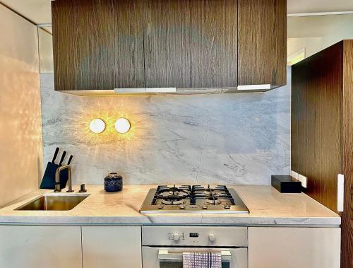 a kitchen with a stove and a sink at High rise top view 2bed2bath in Melbourne