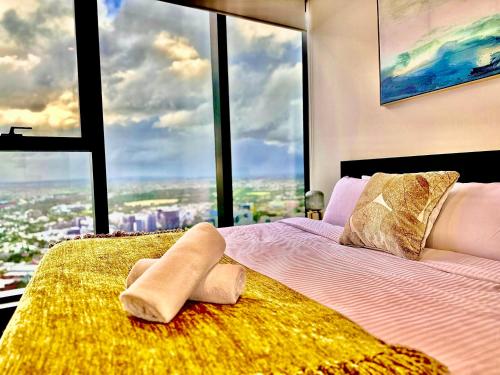a bed in a room with a large window at High rise top view 2bed2bath in Melbourne