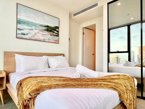 two beds in a room with two windows at High rise top view 2bed2bath in Melbourne