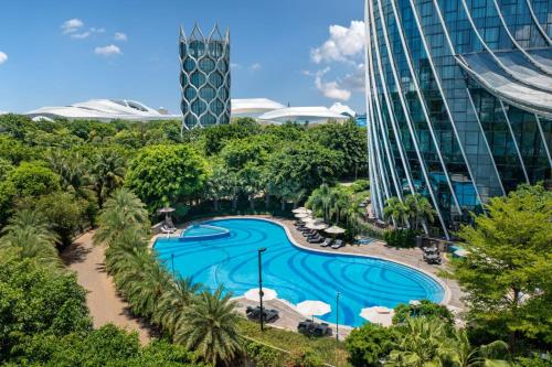 an aerial view of a pool in a resort at Hilton Hainan Ocean Flower Island in Danzhou