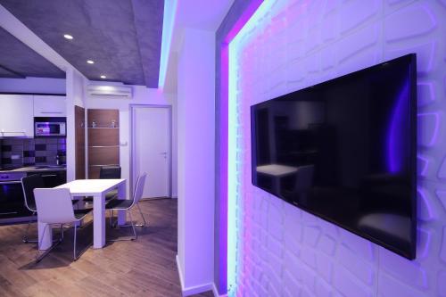 a room with a large tv on a wall at Apartments Belgrade in Belgrade