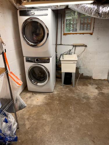 a laundry room with a washing machine and a sink at Historic 1905 craftsman in Centralia