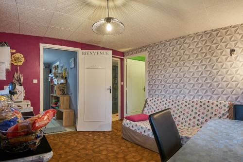 a room with a living room with a couch and a door at Studio in Saint-Victor-de-Cessieu