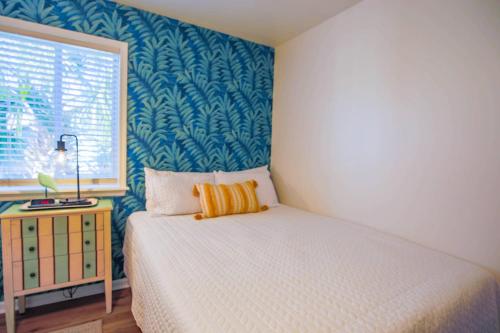 a bedroom with a bed and a window at Shangri-La in Folly Beach