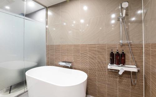 a bathroom with a toilet and a shower at Hotel The One in Incheon