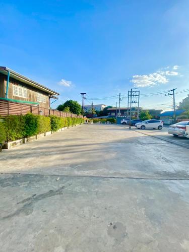 an empty parking lot with cars parked in a parking lot at Nakara Hotel, Ubon Ratchathani in Ban Na Kham