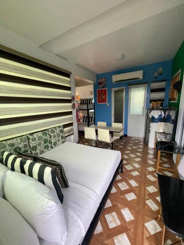 a living room with a white couch and blue walls at Italy Condotel Darasa in Tanauan