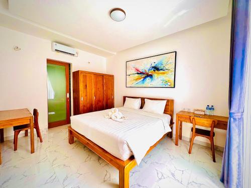 a bedroom with a bed and a desk and a bed sidx sidx sidx at Palm&Ocean Canggu in Canggu