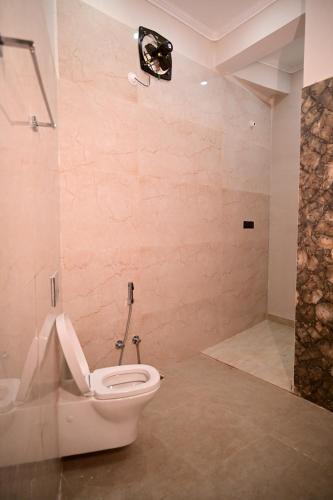 a bathroom with a toilet and a shower at Surendra Villa Home Stay in Ayodhya