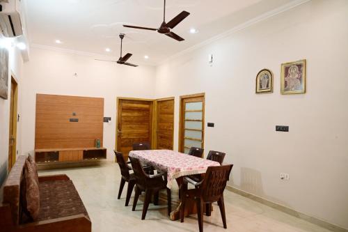 a dining room with a table and chairs at Surendra Villa in Ayodhya