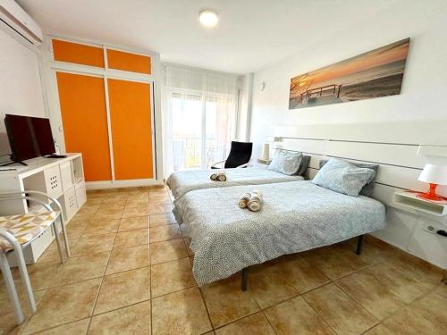 a bedroom with two beds and a television in it at Agata Views in Benalmádena