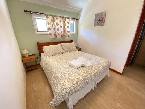 a bedroom with a bed with a towel on it at Departamento estudio para dos personas in Pucón