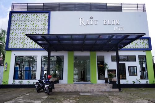 a motorcycle parked in front of a building at Urbanview Hotel Ratu Elok Syariah Banjarbaru by RedDoorz in Martapura