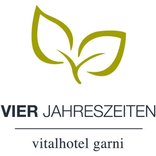 a logo for a vet institution with a green butterfly at Hotel Garni Vier Jahreszeiten in Bad Füssing