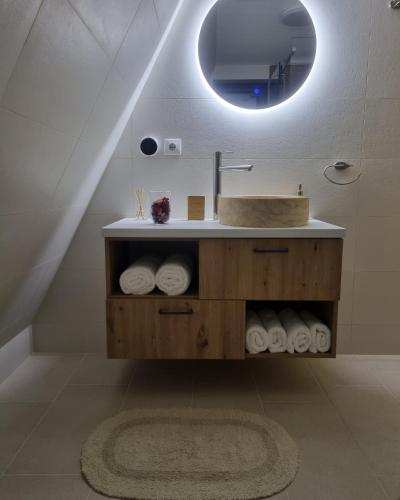a bathroom with a sink and a mirror at Aret House in Avrig