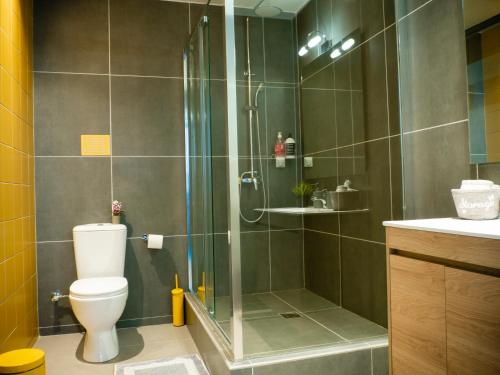 a bathroom with a shower and a toilet at Modern apartment ATG in Athens