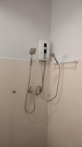 a bathroom with a blow dryer on a wall at Khaolak Summer House 2 in Khao Lak
