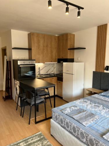 a room with a kitchen and a table and a bed at Sea Dreams in Nesebar