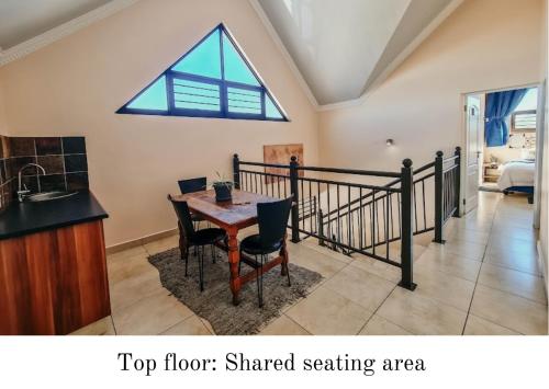 a dining room with a table and a window at Eldorado Lodge CC in Kuruman