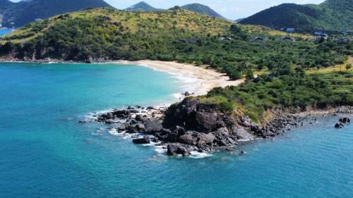 an island in the ocean with a sandy beach at Appartement Saint Martin Friars Bay Sunset Paradise in Friar's Bay