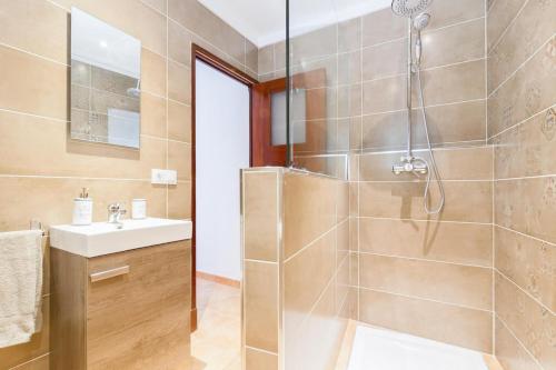 a bathroom with a shower and a sink at Cas Decu in Fornalutx