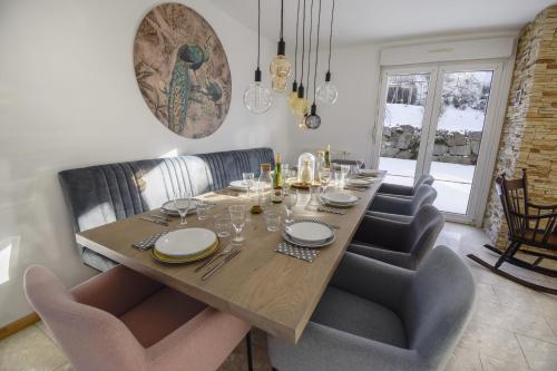 a dining room with a wooden table and chairs at Vacances au Bonhomme in Le Bonhomme