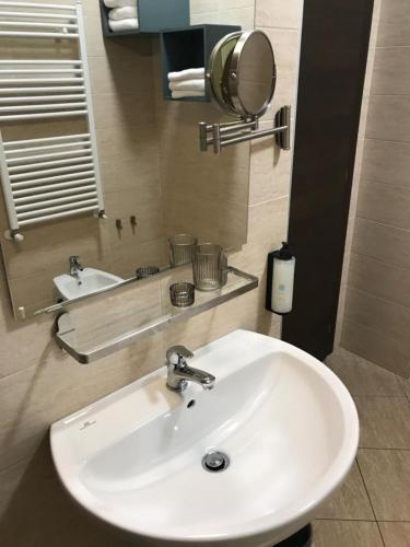 a bathroom with a white sink and a mirror at Palazzo Marignano Hotel in Melegnano