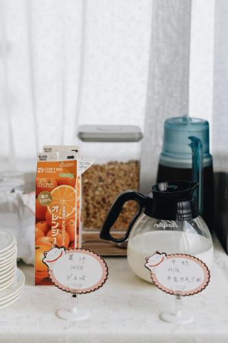a counter top with a tea kettle and a box of food at 雪场缆车站旁 Hotel Justice-Ski IN Ski OUT-独立卫浴 in Seki