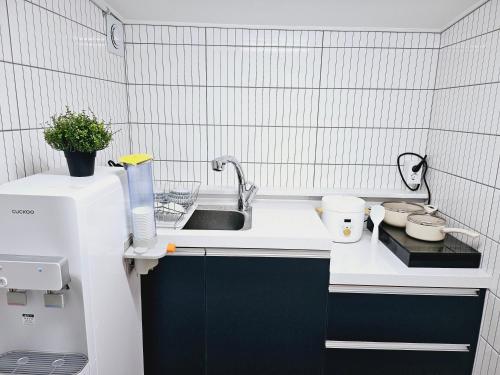 a kitchen with a sink and a counter top at K Highstel in Seoul