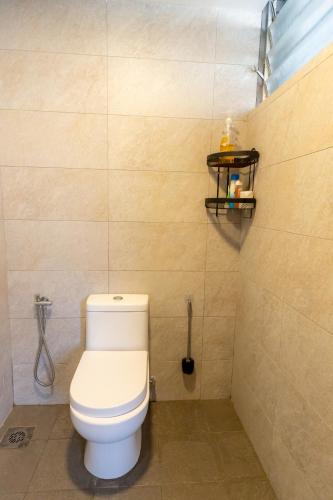 a bathroom with a white toilet in a room at -NEW- 16Px V Kids Pool n KTV n Jacuzzi n Billiard near USM n Penang Bridge in George Town