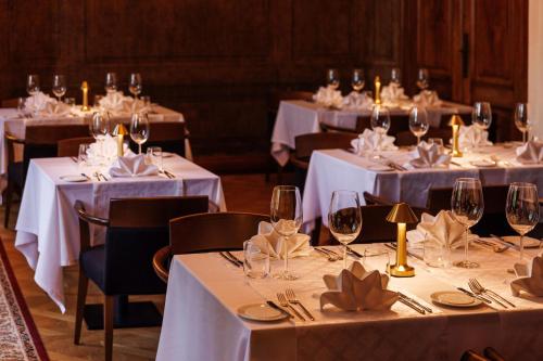 a group of tables with wine glasses and napkins at Schloss Fellin Boutique Hotel and Spa in Viljandi