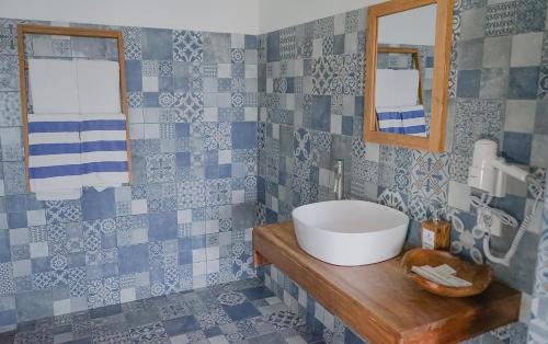 a bathroom with a sink and a mirror at Coconut Lodge Resort in Jepara