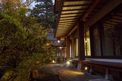 a house with lights on the side of it at night at Ryokan Koyokan in Yasugi