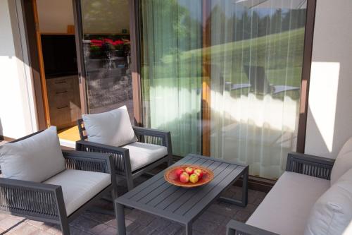a bowl of fruit on a table on a patio at Apt Lara Siela in Ortisei