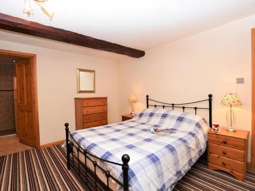 a bedroom with a bed and a dresser and a door at 1 Bed in Godshill IC146 in Godshill