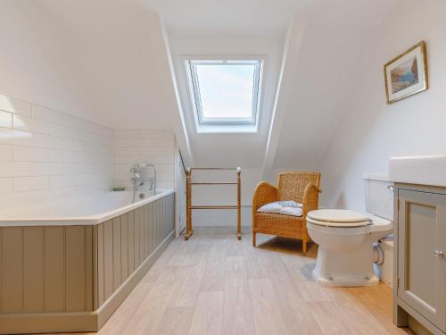 a bathroom with a toilet and a tub and a sink at 3 Bed in Polruan PC009 in Fowey