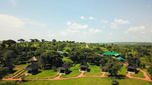 an aerial view of a resort with trees and green roofs at Fort Murchison Lodge by NATURE LODGES LTD in Pakwach East