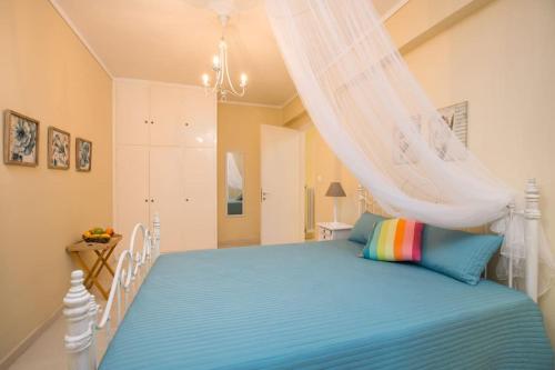a bedroom with a bed with a canopy at Orfeas House Corfu in Corfu Town