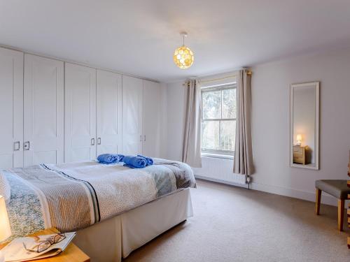 a white bedroom with a bed and a window at 3 Bed in Burnham Deepdale KT045 in Burnham Deepdale