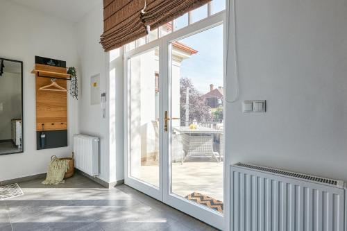 a sliding glass door in a room with a patio at Villa Botaniq in Sopron